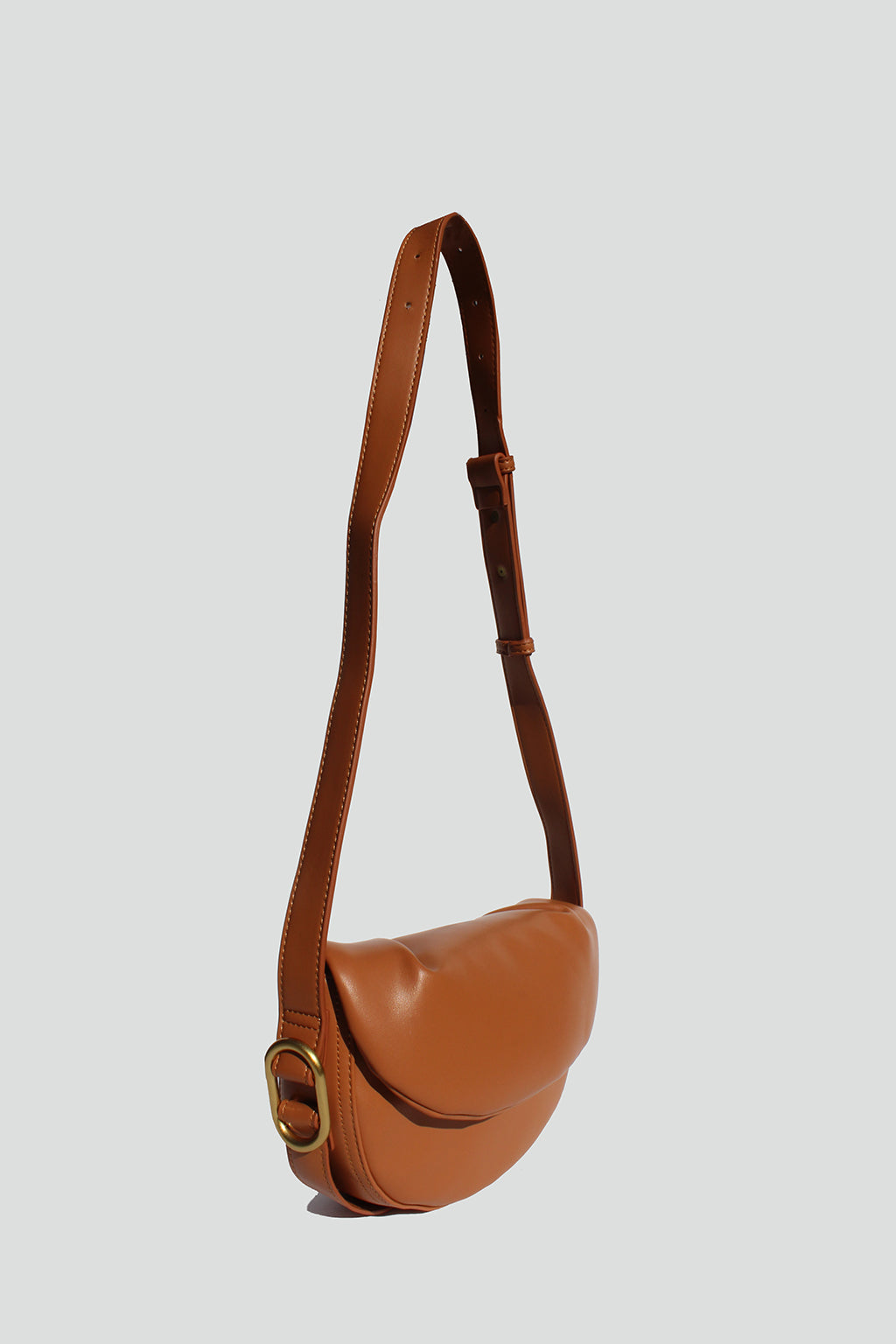 Fleur Half Moon Faux Leather Crossbody Bag in Tan